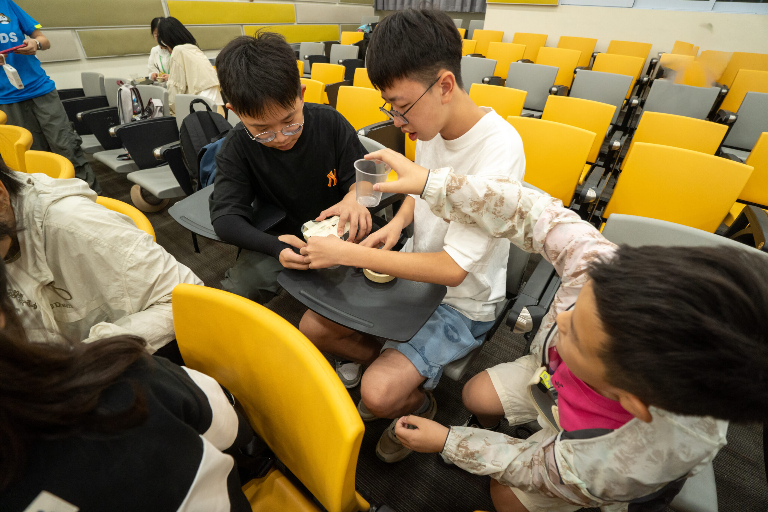 students building a buoyancy vessel during a hands-on project on a STEAM programme.